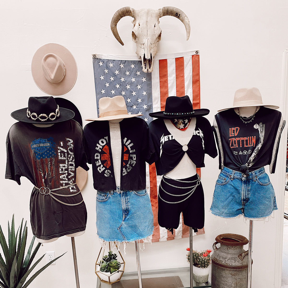 Four mannequins in trendy apparel in from of American flag