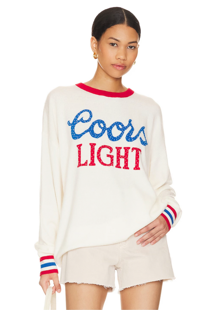 Person wearing a Coors Light Cashmere sweater and shorts on a white background