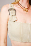 Beige corset with decorative elements on a plain background