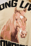 Embroidered horse design on fabric with text 'LONG LIVE', close-up view.