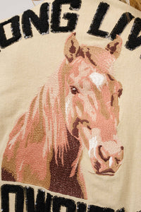 Embroidered horse design on fabric with text 'LONG LIVE', close-up view.