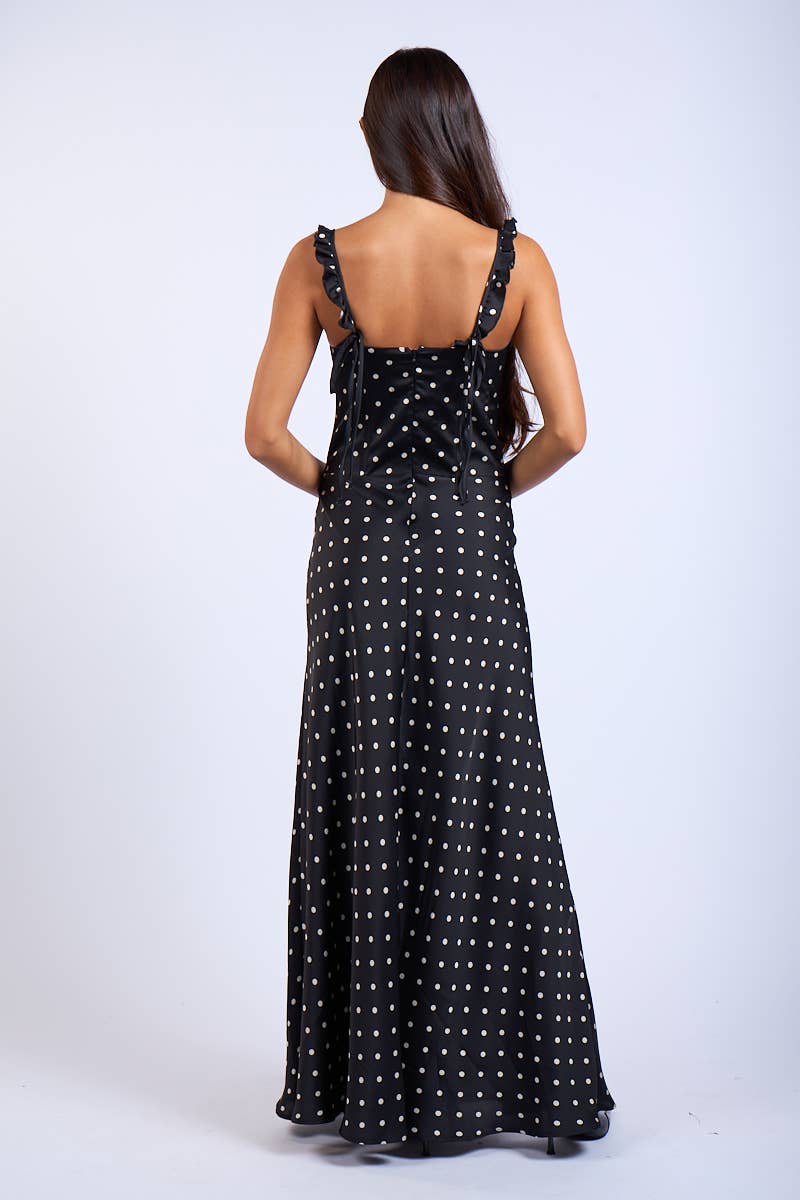 Woman wearing a black polka dot dress on a white background