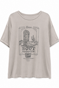 A light beige Coors Boot Scootin' graphic t-shirt with a vintage western-themed print featuring a cowboy boot, cactus, and desert scenery.