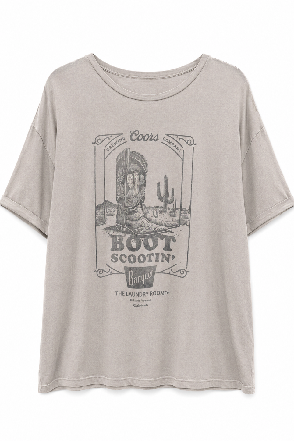 A light beige Coors Boot Scootin' graphic t-shirt with a vintage western-themed print featuring a cowboy boot, cactus, and desert scenery.