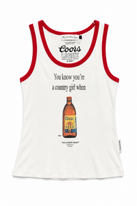 A white tank top with red trim, featuring a vintage Coors Lager advertisement print on the front with the text 'You know you're a country girl when' and an illustration of a Coors beer bottle.