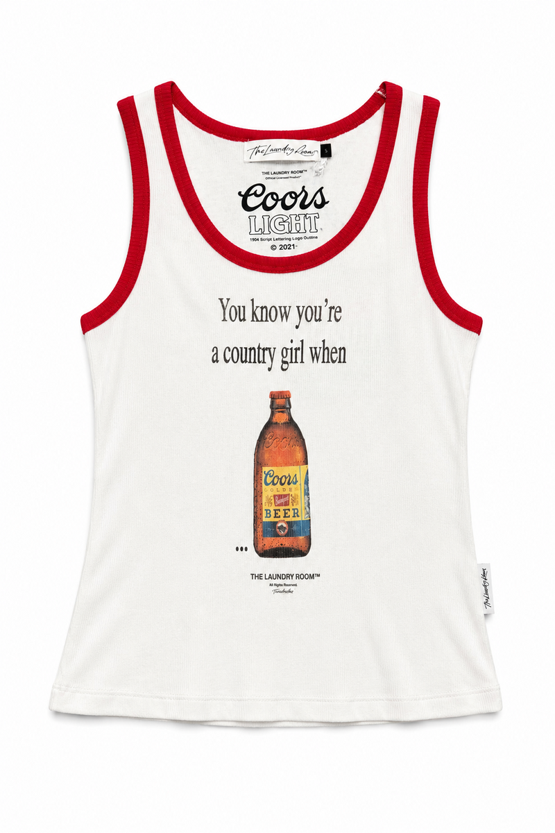 A white tank top with red trim, featuring a vintage Coors Lager advertisement print on the front with the text 'You know you're a country girl when' and an illustration of a Coors beer bottle.