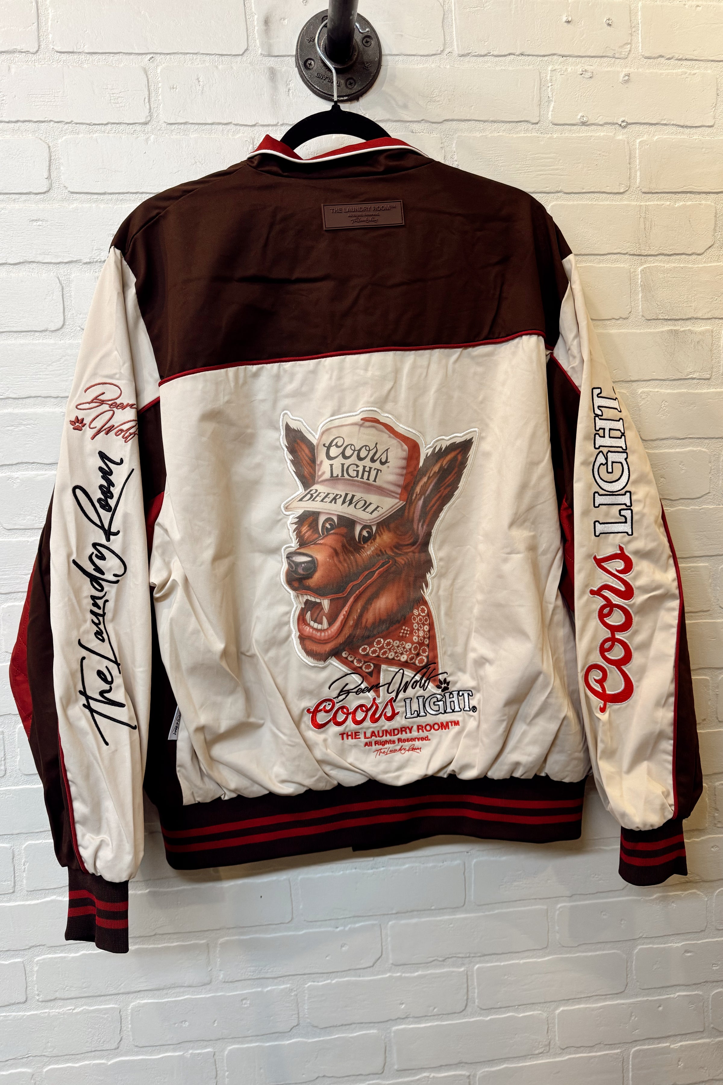 Coors Light branded jacket with logo on a white brick wall background