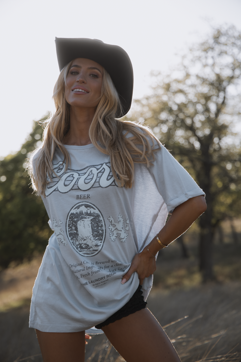 Woman wearing a white t-shirt with a graphic design outdoors