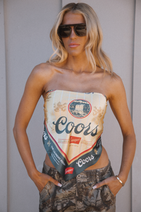 Person wearing a strapless top made from a Coors beer can design.
