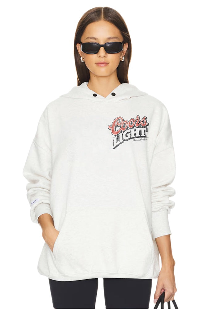 Person wearing a white hoodie with a Coors brand logo on a white background