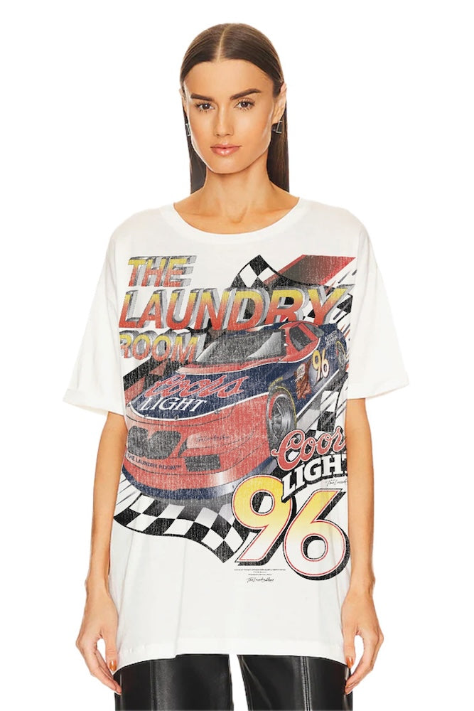 Woman wearing a white t-shirt with colorful coors racing graphic design on a white background