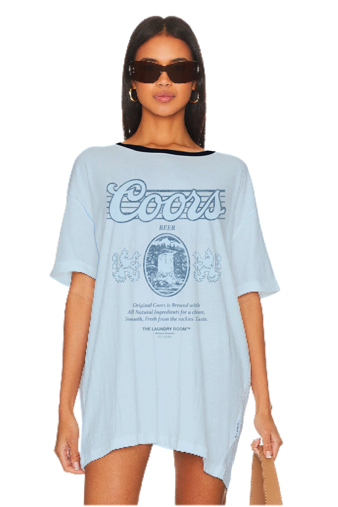 Woman wearing a light blue t-shirt with Coors logo on a white background