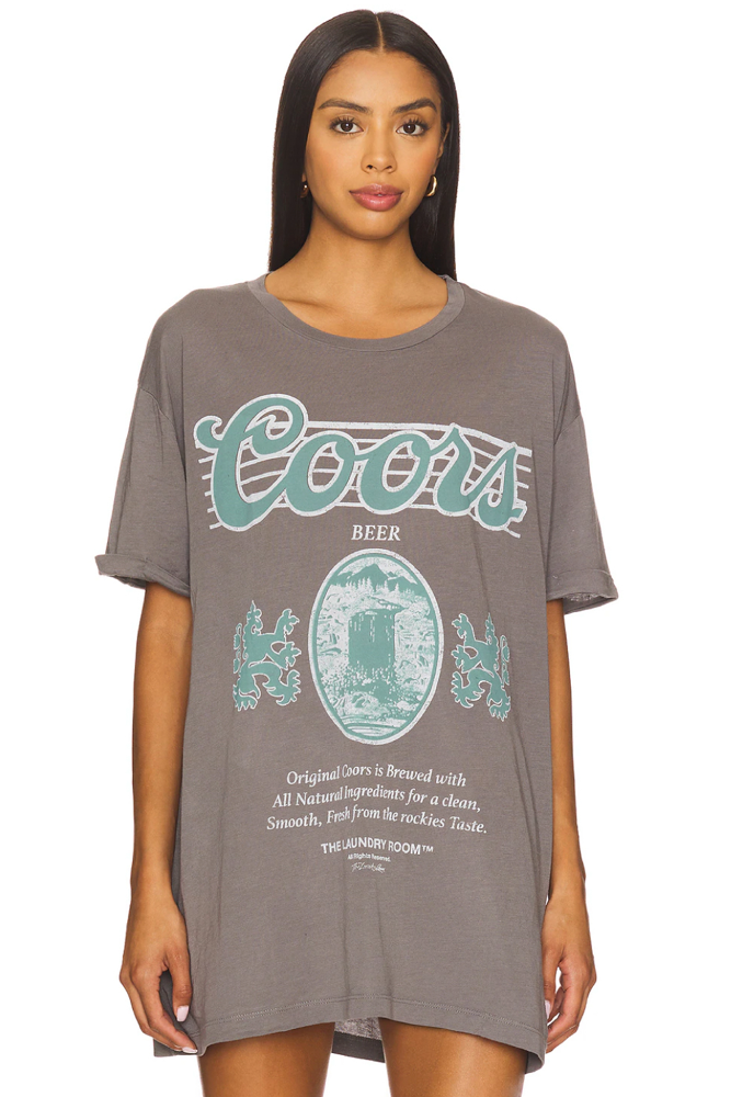 Woman wearing a Coors beer t-shirt on a white background