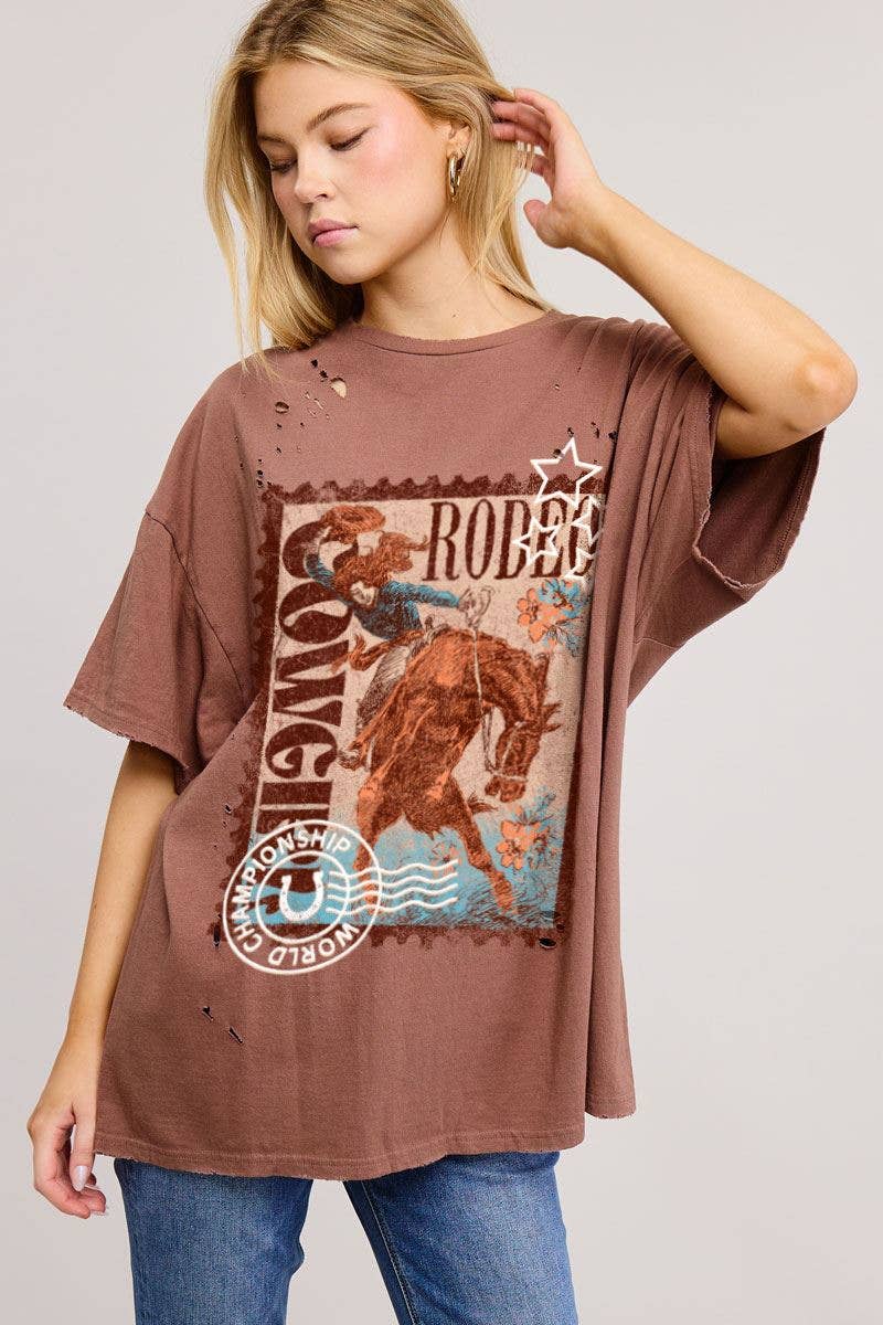 Woman wearing a brown graphic t-shirt with a horse and text design on a plain background