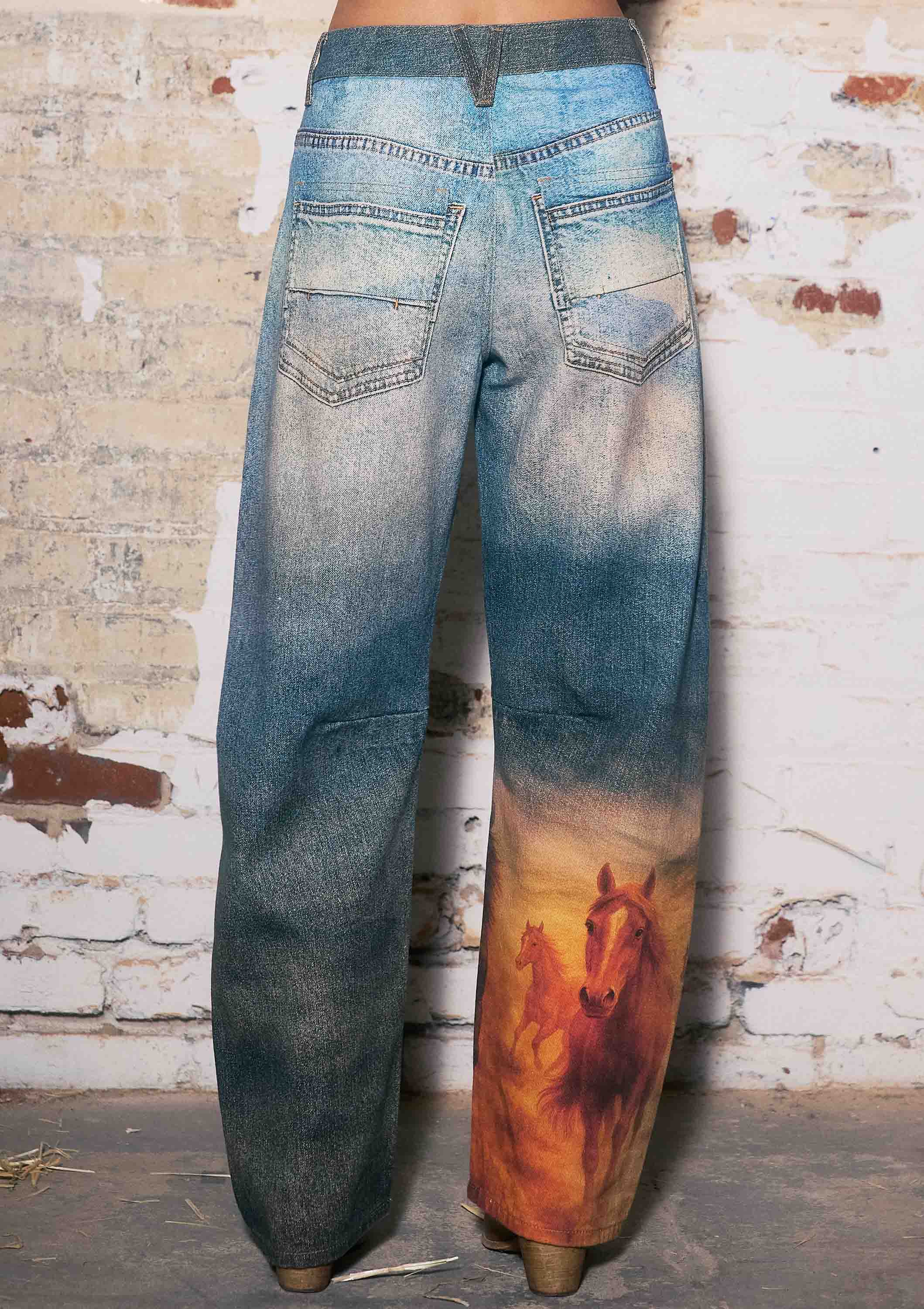 Wide-leg jeans with a horse graphic on the back pocket against a textured wall.