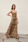 Woman wearing a leopard print strapless gown against a plain background