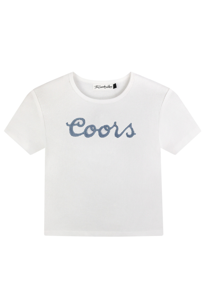White t-shirt with 'Coors' text cutout denim patch sewn on on a white background